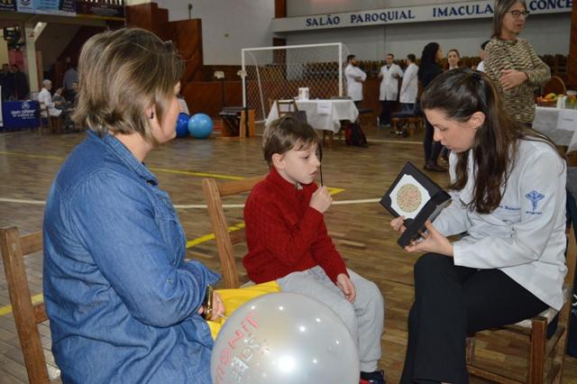 Crianças e adultos realizaram o teste de acuidade visual com a Optometrista Laura Heilmann 